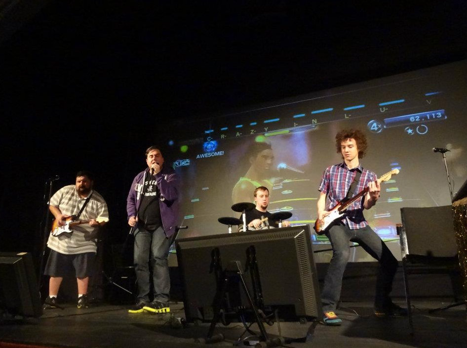 The author on the right playing Rock band with Ryan Davis on a stage.