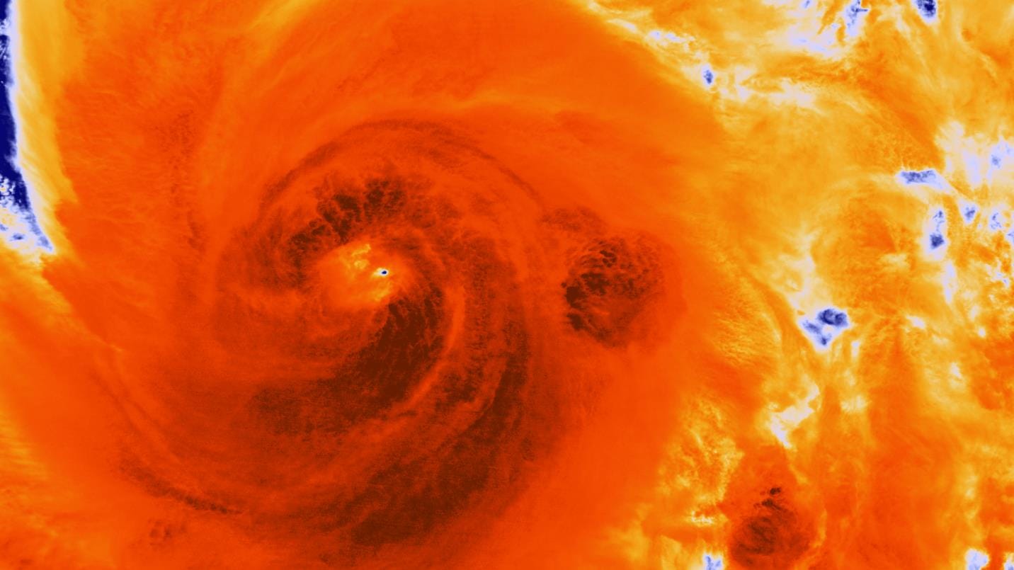 A burnt red-orange infrared photo of Hurricane Sandy's eye.