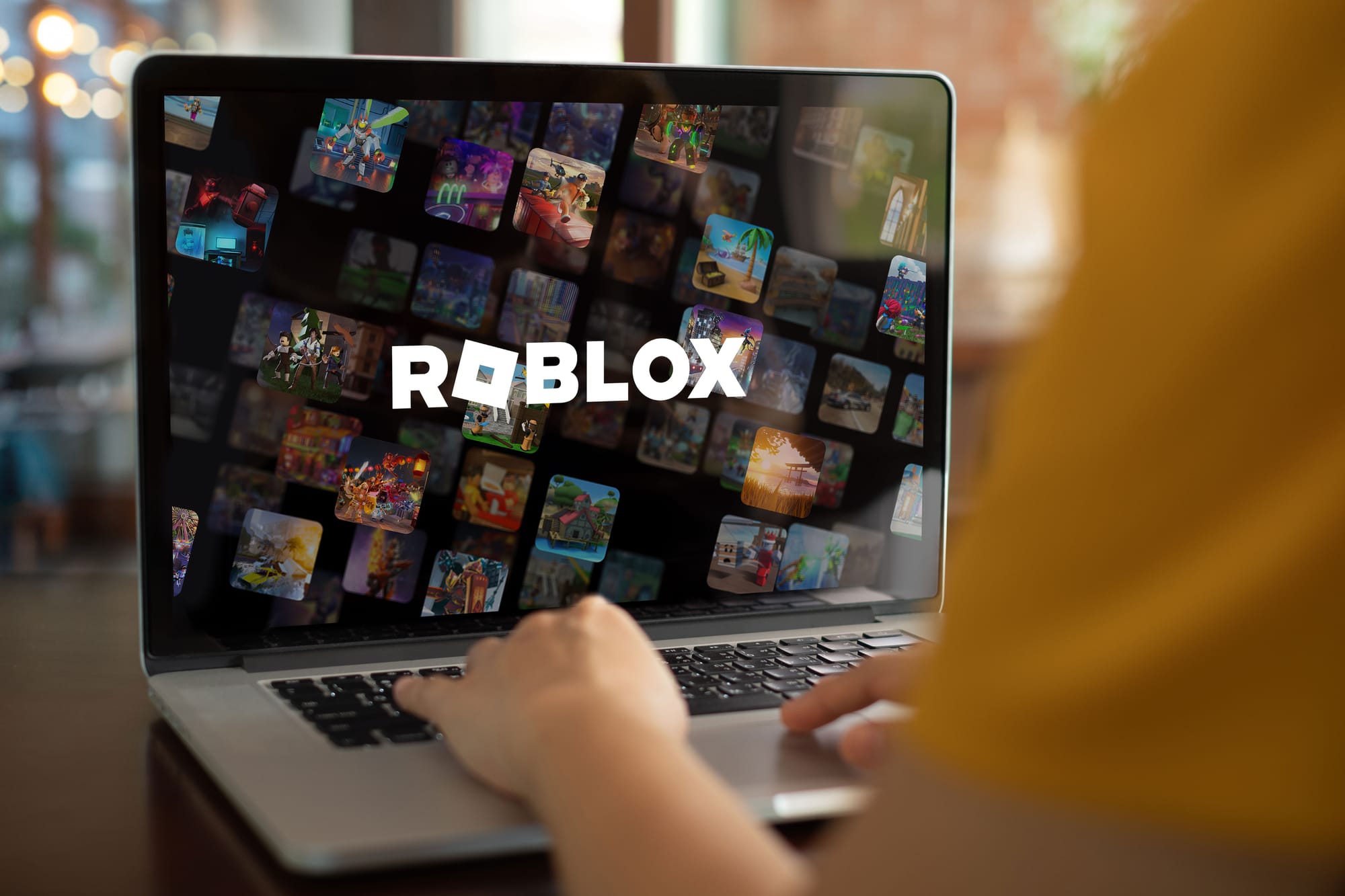 A child playing Roblox on a laptop