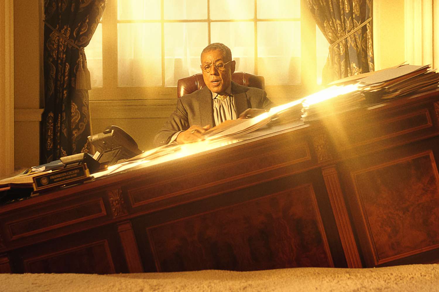  Esposito working at a desk that is canted downward like the deck of a sinking ship.