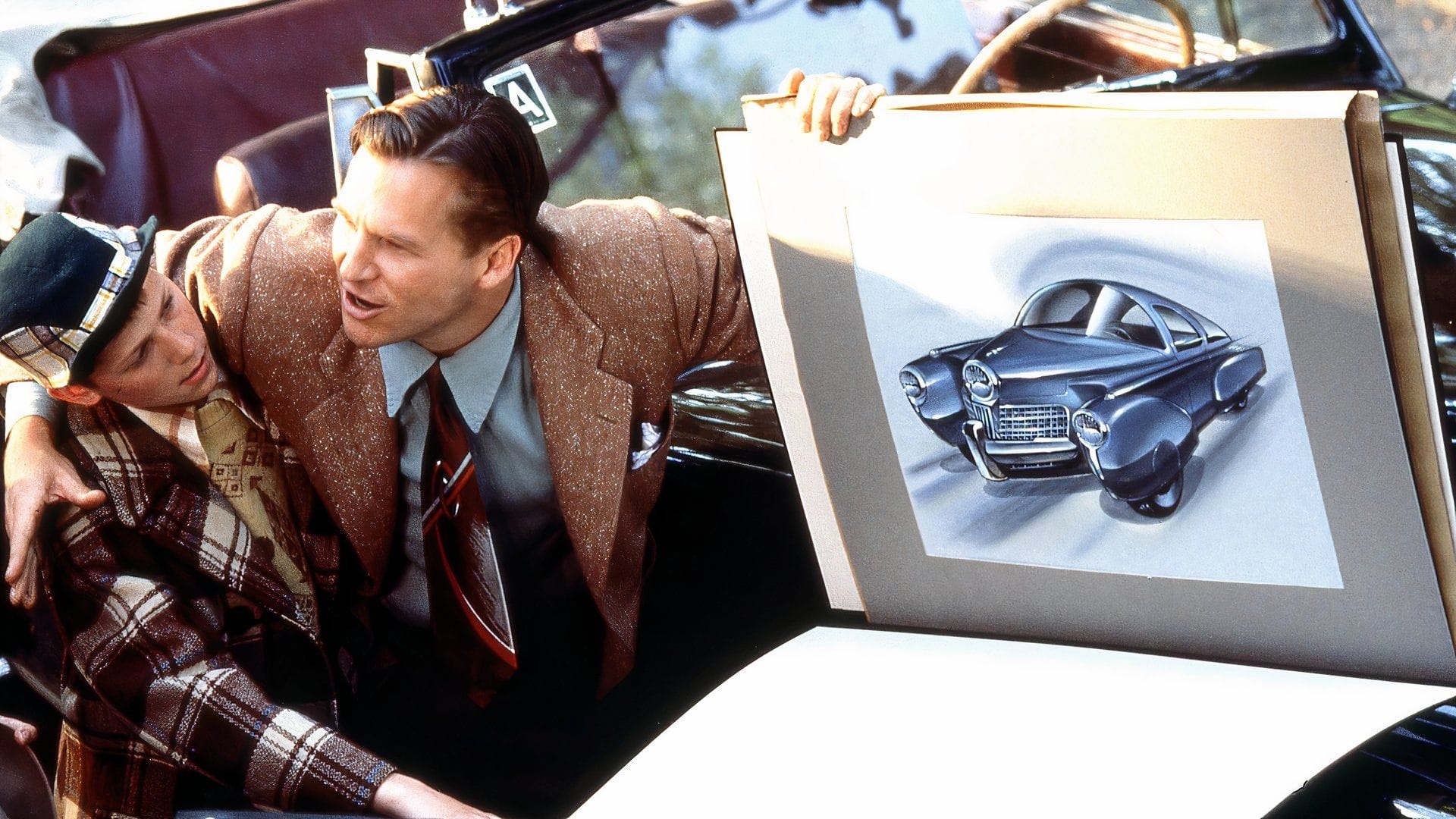 Jeff Bridges holds up a futuristic sketch of a concept car.